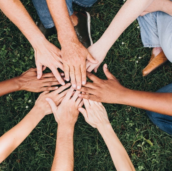 people-stacking-hands-together-park-4